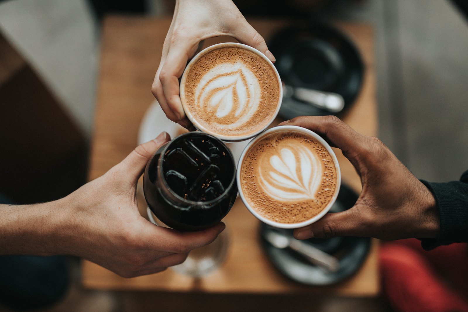 Stock photograph of friends with coffee, not BLAX customers or products